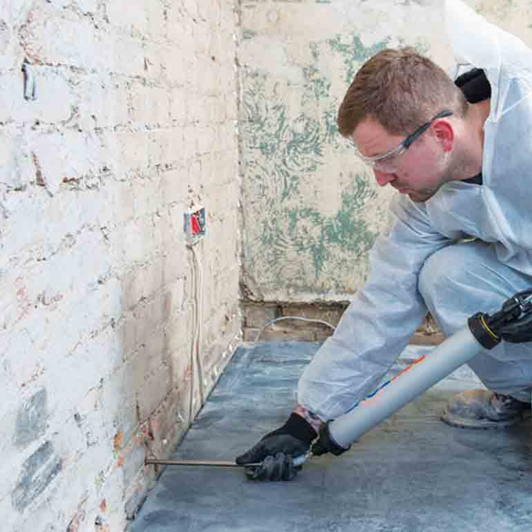 Injecting Dryzone Damp Proofing Cream into wall