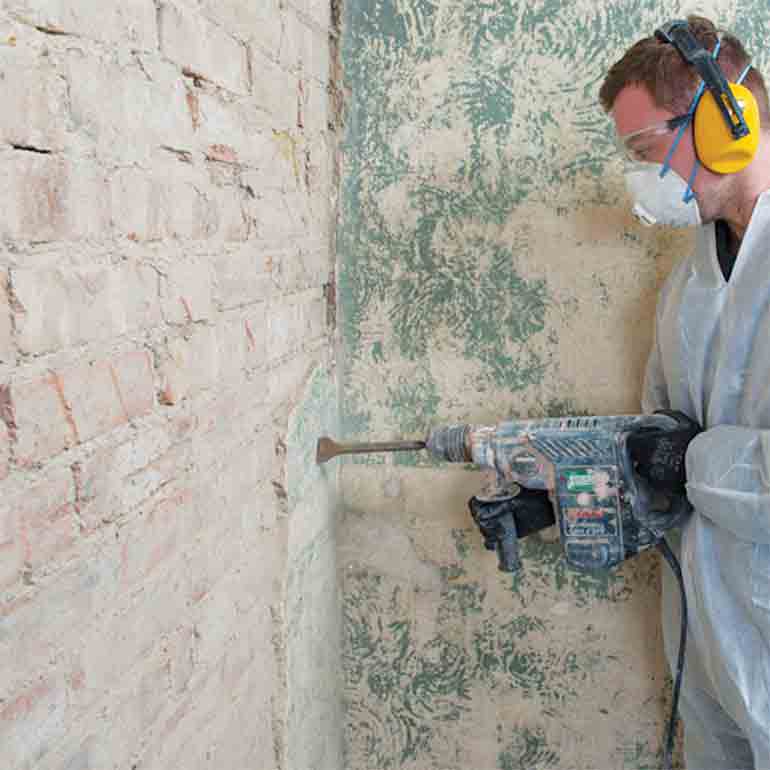 Removing plaster from a damp wall